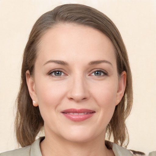 Joyful white young-adult female with medium  brown hair and grey eyes