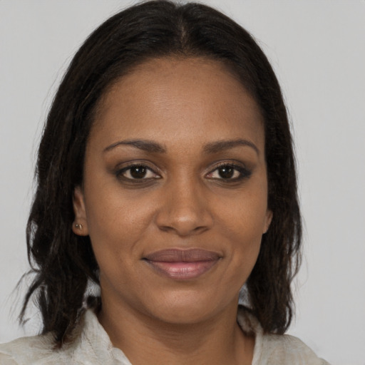 Joyful black young-adult female with medium  brown hair and brown eyes