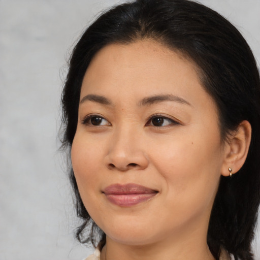 Joyful asian young-adult female with medium  brown hair and brown eyes