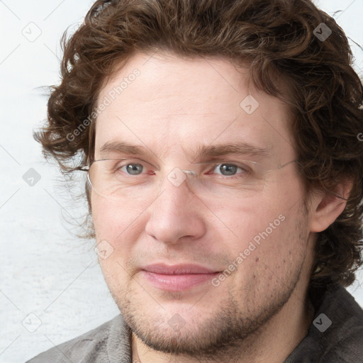 Joyful white adult male with short  brown hair and grey eyes