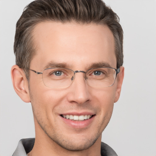 Joyful white adult male with short  brown hair and grey eyes