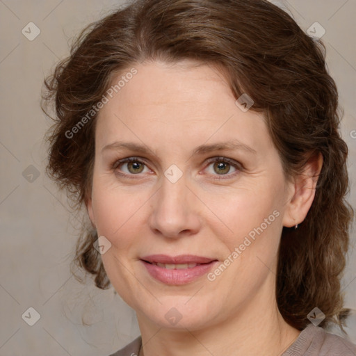 Joyful white adult female with medium  brown hair and blue eyes