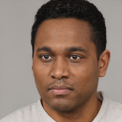 Neutral black young-adult male with short  black hair and brown eyes