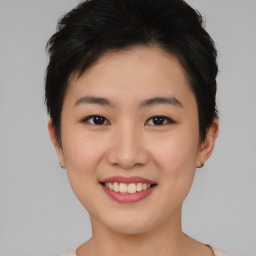 Joyful asian young-adult female with short  brown hair and brown eyes