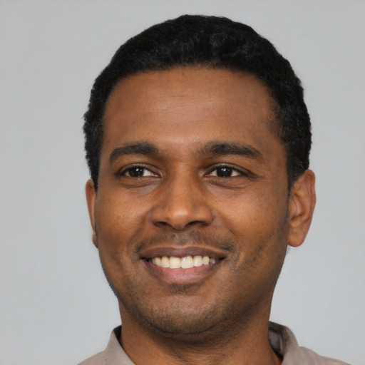 Joyful latino young-adult male with short  black hair and brown eyes