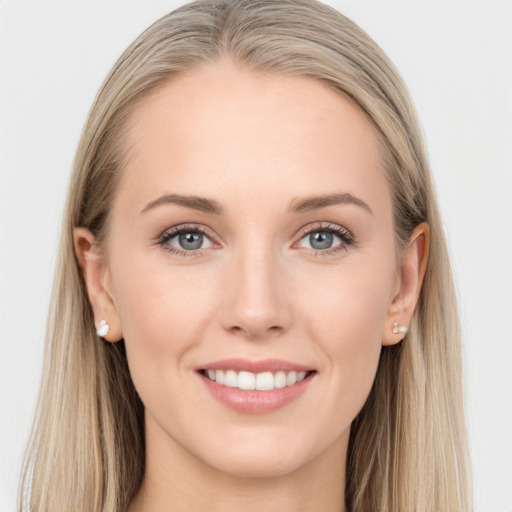 Joyful white young-adult female with long  brown hair and blue eyes