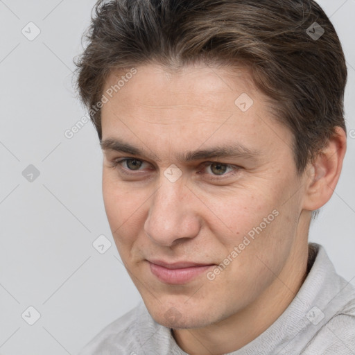 Joyful white adult male with short  brown hair and brown eyes