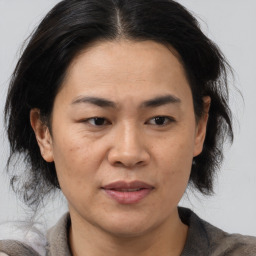 Joyful latino adult female with medium  brown hair and brown eyes