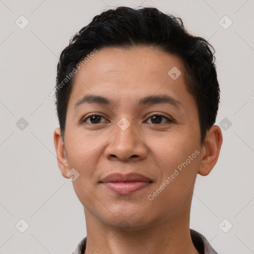 Joyful latino young-adult male with short  brown hair and brown eyes