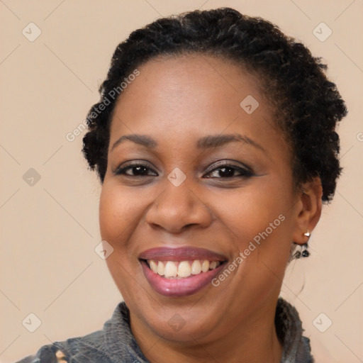 Joyful black adult female with short  brown hair and brown eyes