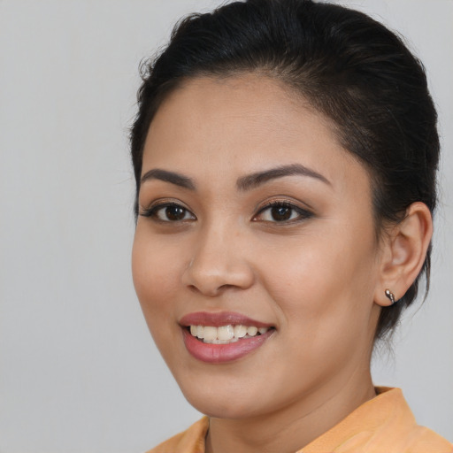 Joyful asian young-adult female with medium  brown hair and brown eyes