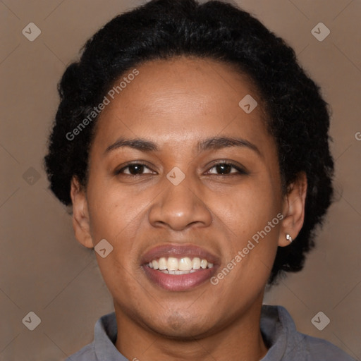 Joyful black adult female with short  black hair and brown eyes