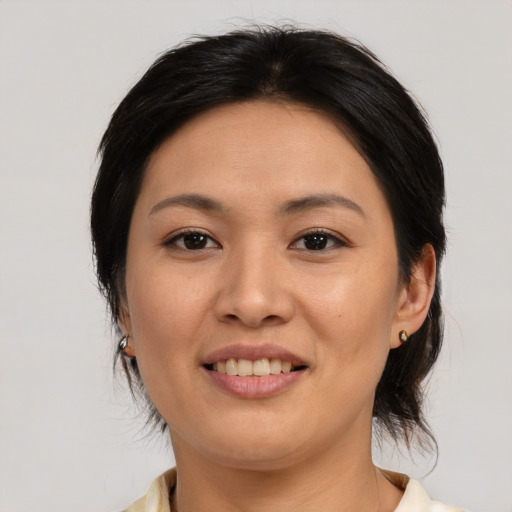 Joyful asian young-adult female with medium  brown hair and brown eyes