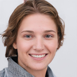 Joyful white young-adult female with medium  brown hair and blue eyes