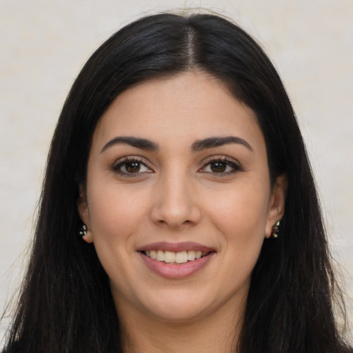 Joyful latino young-adult female with long  black hair and brown eyes
