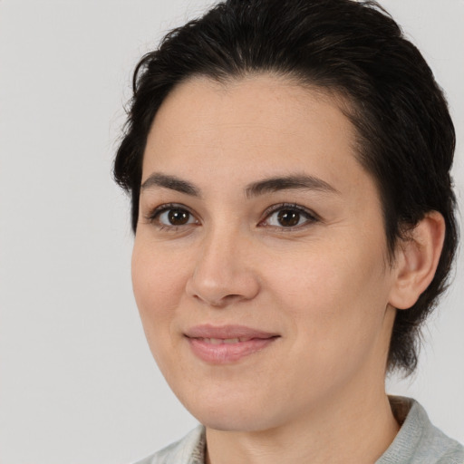 Joyful white young-adult female with medium  brown hair and brown eyes