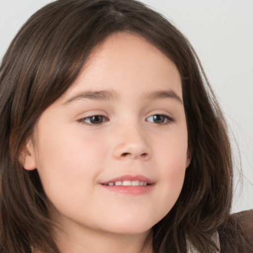 Joyful white child female with long  brown hair and brown eyes