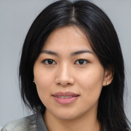 Joyful asian young-adult female with medium  black hair and brown eyes