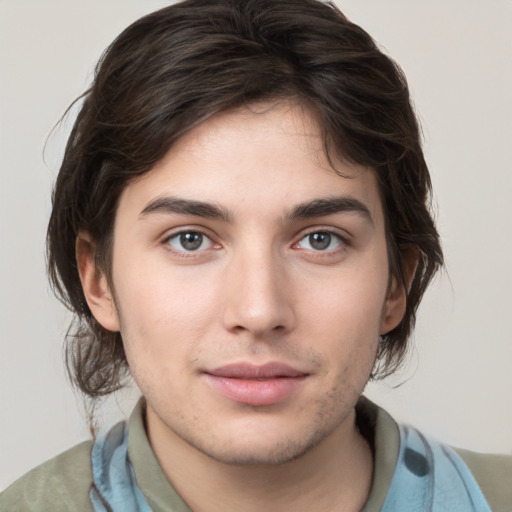 Joyful white young-adult male with medium  brown hair and brown eyes