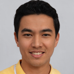 Joyful asian young-adult male with short  black hair and brown eyes