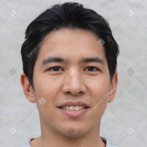 Joyful asian young-adult male with short  brown hair and brown eyes