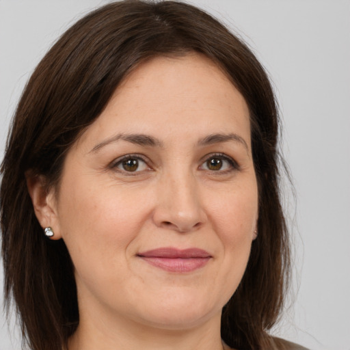 Joyful white adult female with medium  brown hair and brown eyes