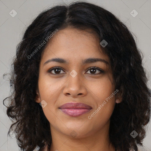 Joyful black young-adult female with long  brown hair and brown eyes