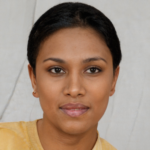 Joyful black young-adult female with short  brown hair and brown eyes