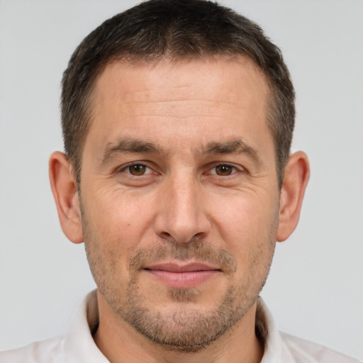 Joyful white adult male with short  brown hair and brown eyes