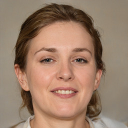 Joyful white young-adult female with medium  brown hair and blue eyes