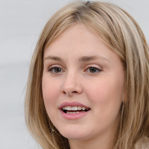 Joyful white young-adult female with medium  brown hair and grey eyes