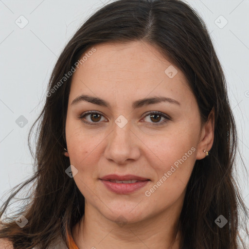 Joyful white adult female with long  brown hair and brown eyes