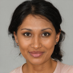 Joyful black young-adult female with medium  brown hair and brown eyes