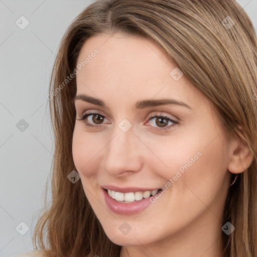 Joyful white young-adult female with long  brown hair and brown eyes