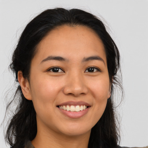 Joyful asian young-adult female with long  brown hair and brown eyes