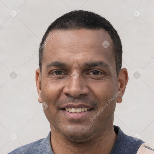 Joyful white adult male with short  black hair and brown eyes