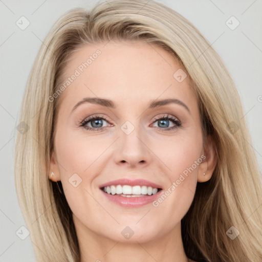 Joyful white young-adult female with long  brown hair and blue eyes