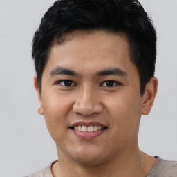 Joyful asian young-adult male with short  black hair and brown eyes