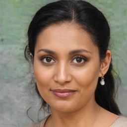 Joyful latino young-adult female with medium  brown hair and brown eyes