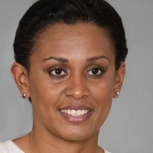 Joyful black young-adult female with short  brown hair and brown eyes
