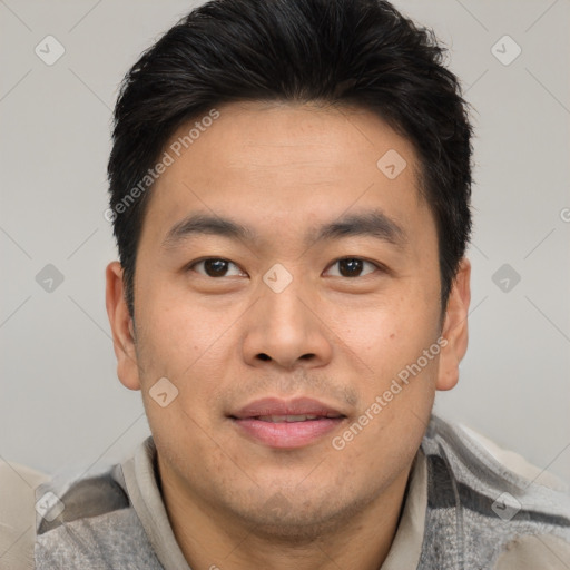 Joyful asian young-adult male with short  brown hair and brown eyes