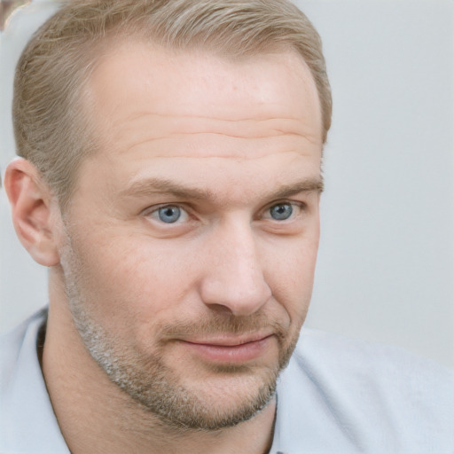 Joyful white adult male with short  brown hair and blue eyes