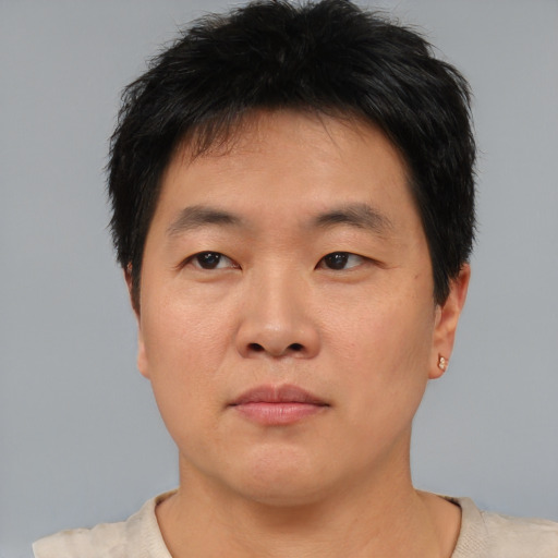 Neutral asian young-adult male with short  brown hair and brown eyes