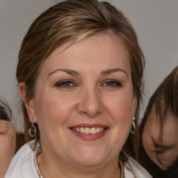 Joyful white adult female with medium  brown hair and brown eyes