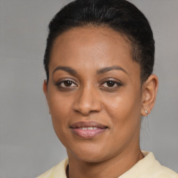 Joyful latino young-adult female with short  brown hair and brown eyes