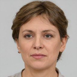 Joyful white adult female with short  brown hair and grey eyes