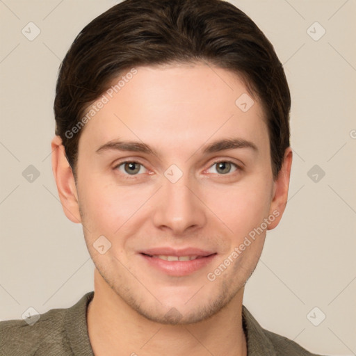 Joyful white young-adult male with short  brown hair and grey eyes