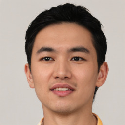 Joyful asian young-adult male with short  black hair and brown eyes