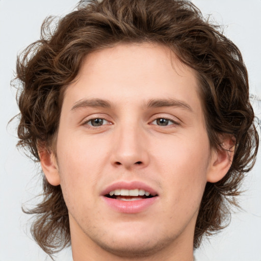 Joyful white young-adult male with medium  brown hair and brown eyes