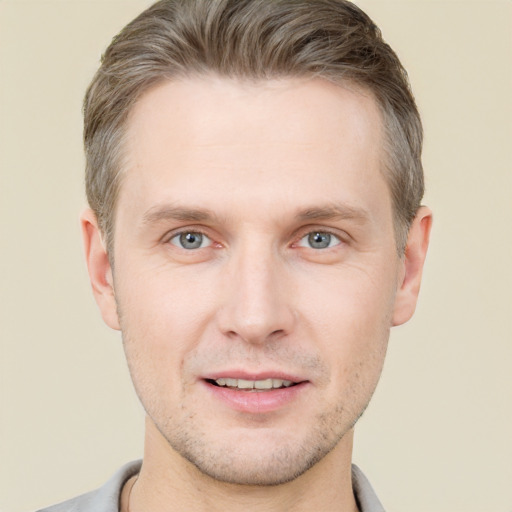 Joyful white young-adult male with short  brown hair and grey eyes